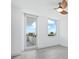 Light and airy bedroom featuring wood-look floors and large windows with a clear view to the outside balcony at 800 N Tamiami Trl # 307, Sarasota, FL 34236