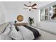 Bright bedroom featuring a ceiling fan, light grey floors, and a large window offering ample natural light at 800 N Tamiami Trl # 307, Sarasota, FL 34236
