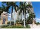 Beautiful exterior of Alinari condos with lush landscaping and palm trees at 800 N Tamiami Trl # 307, Sarasota, FL 34236