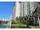 Scenic exterior view of the Alinari condos featuring a fountain and lush landscaping at 800 N Tamiami Trl # 307, Sarasota, FL 34236