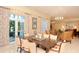 Bright dining area featuring an elegant chandelier, table, and patterned chairs near a doorway at 800 N Tamiami Trl # 307, Sarasota, FL 34236