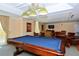 Spacious game room with a pool table and lounge seating under decorative chandelier lighting at 800 N Tamiami Trl # 307, Sarasota, FL 34236