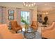 Inviting lounge area with comfortable leather chairs, a glass coffee table, and natural light from the windows at 800 N Tamiami Trl # 307, Sarasota, FL 34236