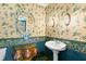 Elegant powder room with pedestal sink, ornate mirror, and floral wallpaper at 810 S Edison Ave, Tampa, FL 33606