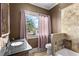 Updated bathroom with a tiled shower and dark vanity at 810 S Edison Ave, Tampa, FL 33606