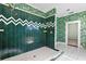 Elegant bathroom with a walk-in shower and tropical-themed wallpaper at 810 S Edison Ave, Tampa, FL 33606