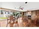 Sunlit dining area with hardwood floors, glass-top table, and backyard access at 810 S Edison Ave, Tampa, FL 33606