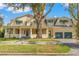 Large two-story home with a wrap-around porch and two-car garage at 810 S Edison Ave, Tampa, FL 33606