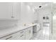 Bright laundry room with white cabinets and double sinks at 810 S Edison Ave, Tampa, FL 33606