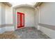 Elegant red double doors with a decorative archway and stone path at 818 Oak Pond Dr, Osprey, FL 34229