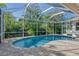 Relaxing pool and patio area with screened enclosure at 818 Oak Pond Dr, Osprey, FL 34229