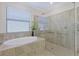 Bathroom featuring a shower, soaking tub, and modern fixtures at 10202 Marbella Dr, Bradenton, FL 34211