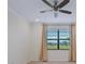 Spacious bedroom with ceiling fan, large window, and neutral color palette at 10202 Marbella Dr, Bradenton, FL 34211