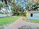 Landscaped backyard with a brick pathway and detached garage at 1127 41St St, Sarasota, FL 34234