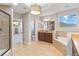 Spa-like bathroom with soaking tub, walk-in shower, and dual vanities at 13148 Bliss Loop, Bradenton, FL 34211