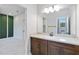 Vanity with brown cabinets and a large mirror in the bathroom at 13148 Bliss Loop, Bradenton, FL 34211