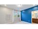 Bedroom with blue accent wall, window, and en-suite bathroom at 13148 Bliss Loop, Bradenton, FL 34211