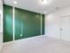 Bedroom with a green accent wall and a door to hallway at 13148 Bliss Loop, Bradenton, FL 34211