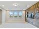 Bonus room with wood feature wall, TV space, and abundant natural light at 13148 Bliss Loop, Bradenton, FL 34211