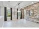 Elegant dining room with a stone accent wall and chandelier at 13148 Bliss Loop, Bradenton, FL 34211
