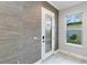 Bright entryway with textured wallpaper and a window at 13148 Bliss Loop, Bradenton, FL 34211