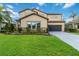 Two-story house with stone accents and a landscaped lawn at 13148 Bliss Loop, Bradenton, FL 34211