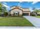 Two-story house with stone accents and a landscaped lawn at 13148 Bliss Loop, Bradenton, FL 34211