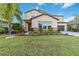 Two-story house with stone accents and a landscaped lawn at 13148 Bliss Loop, Bradenton, FL 34211