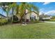 Two-story house with palm trees and a landscaped lawn at 13148 Bliss Loop, Bradenton, FL 34211
