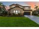 Two-story house with stone accents and a landscaped lawn at 13148 Bliss Loop, Bradenton, FL 34211
