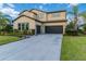 Two-story house with dark-colored garage doors and a landscaped lawn at 13148 Bliss Loop, Bradenton, FL 34211