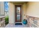 Elegant front door with glass inserts and a welcome mat at 13148 Bliss Loop, Bradenton, FL 34211