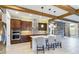 Open kitchen with island, stainless steel appliances & wood beams at 13148 Bliss Loop, Bradenton, FL 34211