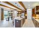 Open kitchen with island, stainless steel appliances & wood beams at 13148 Bliss Loop, Bradenton, FL 34211