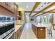 Spacious kitchen with island, stainless steel appliances, and wood beams at 13148 Bliss Loop, Bradenton, FL 34211