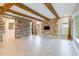 Open living room with stone wall and wood beams at 13148 Bliss Loop, Bradenton, FL 34211