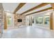 Spacious living room featuring a wood accent wall and exposed beams at 13148 Bliss Loop, Bradenton, FL 34211