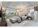 Spacious main bedroom with stylish window treatments and a decorative tray ceiling at 13148 Bliss Loop, Bradenton, FL 34211
