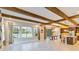 Open concept living area showcasing kitchen, dining, and living spaces with exposed beams at 13148 Bliss Loop, Bradenton, FL 34211