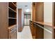 Spacious walk-in closet with custom built-ins and ample shelving at 13148 Bliss Loop, Bradenton, FL 34211