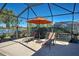 Relaxing poolside patio with lounge chairs and umbrella at 13421 Orino St, Venice, FL 34293