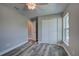 Neutral bedroom featuring a window and closet, and gray wood-look flooring at 160 Apollo Dr, Rotonda West, FL 33947