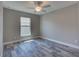 Well-lit bedroom featuring wood-look tile floors and ceiling fan at 160 Apollo Dr, Rotonda West, FL 33947