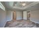 Bedroom with a ceiling fan and gray wood-look tile flooring at 160 Apollo Dr, Rotonda West, FL 33947
