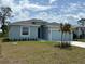 Charming single-story home features a manicured lawn and an attached two-car garage at 160 Apollo Dr, Rotonda West, FL 33947