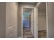 Hallway with white doors and gray wood-look tile flooring at 160 Apollo Dr, Rotonda West, FL 33947