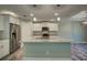 Contemporary kitchen with a granite island, stainless steel appliances, and pendant lighting at 160 Apollo Dr, Rotonda West, FL 33947