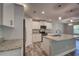 New kitchen with stainless steel appliances, granite counters and gray wood-look tile flooring at 160 Apollo Dr, Rotonda West, FL 33947