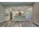 Open kitchen with stainless steel appliances, granite countertops, and a large island at 160 Apollo Dr, Rotonda West, FL 33947