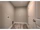 Convenient laundry room with tile flooring and built-in shelving at 160 Apollo Dr, Rotonda West, FL 33947